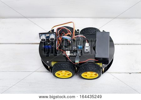 robot on four wheels and the various conductors. flat lay