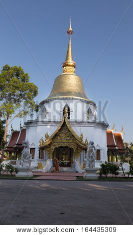 Buddhist Monk Working With Broom Sweeps Floor In Front Of Golden Pagoda