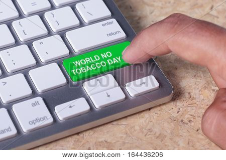 Man pressed keyboard button with World No Tobacco Day