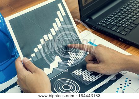 Business Workers Discussing Digital Graphs And Diagrams Indicating Progres.