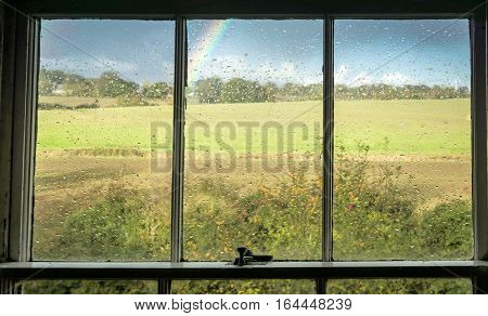 Looking out to a rainbow through a window
