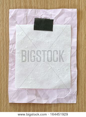 Pink notepad paper crumpled of empty and copy space on wooden backgroundYou can input the message text in picture.