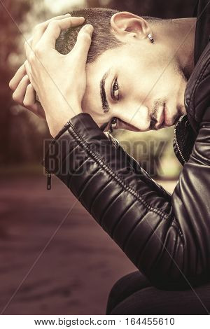Stress, youth problems. Performance anxiety. Young and handsome man with his hands on his head.