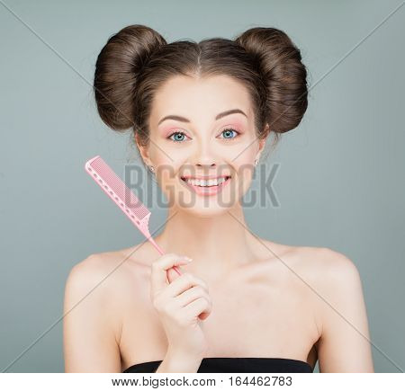Happy Woman with Pretty Hairstyle Holding Сomb. Beautiful Model with Brown Hair and Cute Face. Beauty Salon Background