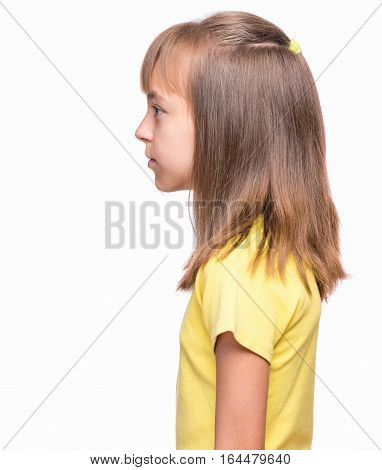 Half-length emotional portrait of caucasian girl wearing yellow t-shirt. Profile of funny cute child, isolated on white background.