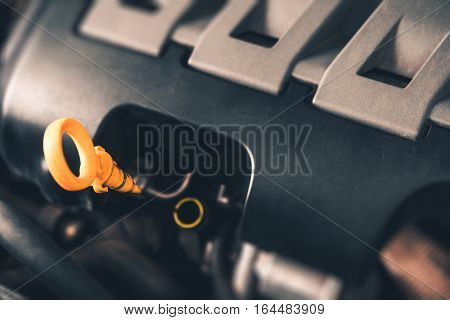 Car Engine Oil Check Photo Concept. Modern Car Engine Closeup on Dipstick