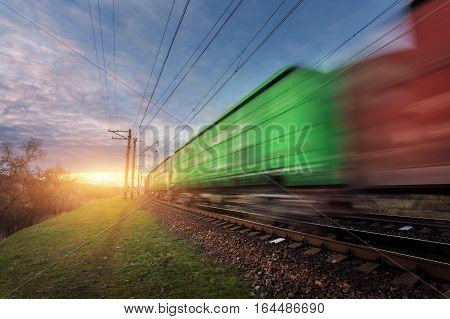 Railway Station With Cargo Wagons In Motion At Sunset