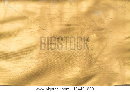Gold texture with kinks and scratches abstract background. Golden background