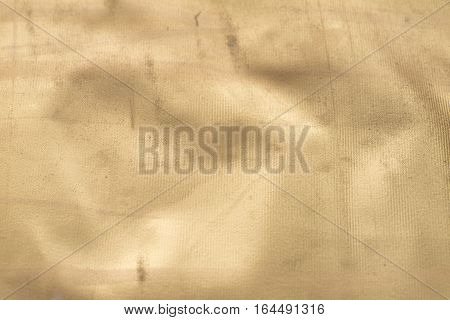 Gold texture with kinks and scratches abstract background. Golden background