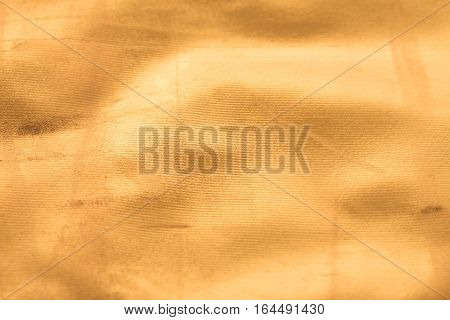 Gold texture with kinks and scratches abstract background. Golden background