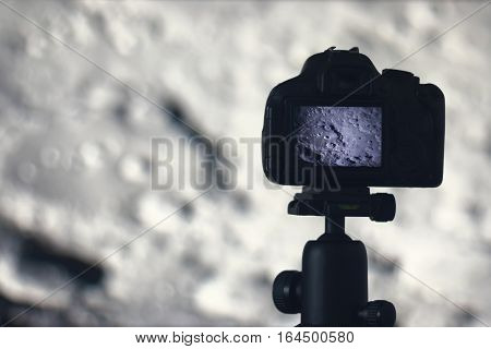 Moon Photography. Camera With Tripod Capturing Moon. Moon Crater Clavius.