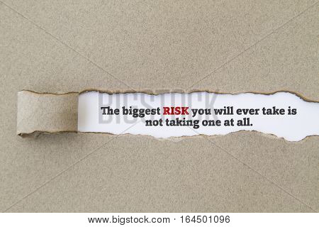 The biggest risk you will ever take is not taking one at all message written under torn paper.
