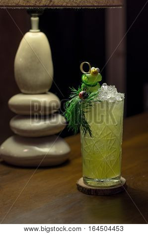 Cold cocktail with cucumber and parsley decorated with bee and ladybug