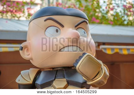 Hong Kong, China - December 5, 2016: portrait of Shau Sing Chai, statue of famous characters, in Hong Kong Avenue of Comic Stars, Kowloon Park. Defocused background of Tsim Sha Tsui District.