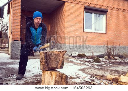 Sporty Man With Expressive Face Chops Wood