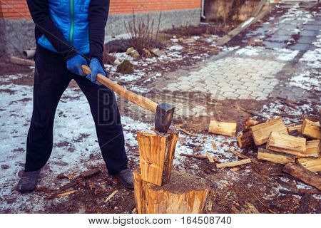 Man With A Axe In His Hand In The Process Of Cutting Wood