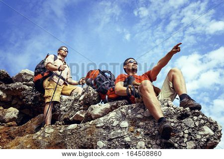Two men in the beautiful mountains with backpacks.