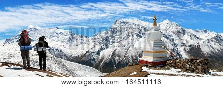 Panoramic view of Annapurna 2 II 3 III 4 IV Ganggapurna and Khangsar Kang from Ice Lake buddhist stupa and tourists way to Thorung La pass Annapurna circuit trek Nepal