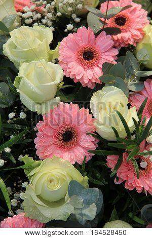 Big white roses and pink gerbers in a floral wedding arrangement