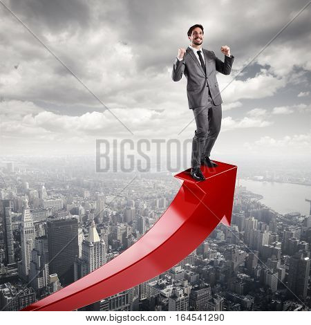 Businessman exults over a red uphill arrow. Economic success concept