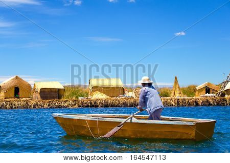 UROS FLOATING ISLANDS PERU - SEPTEMBER 19: Woman in a small boat in the Uros Floating Islands Peru on September 19 2014