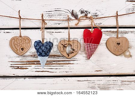 Hearts on string. Hearts on white wooden background. Results of handmade.