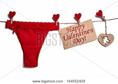 Red lingerie on white background. Card and hearts on rope. Styte combined with passion.