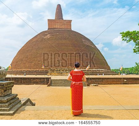 The tourist watches the giant Abhayagiri Stupa one of the famous archaeological sites and functioning monastic complex Anuradhapura Sri Lanka.