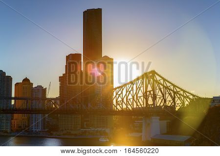 BRISBANE, AUSTRALIA - AUGUST 21 2016: Sunset flare, Brisbane Cityscape and Story Bridge silhouette