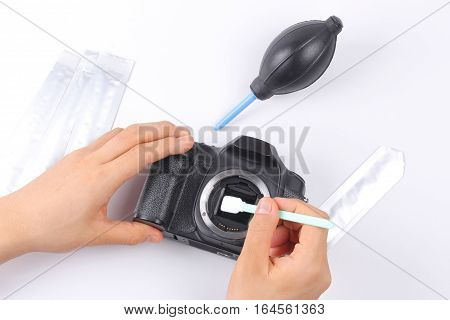 Photographer Hand Cleaning Sensor Of Camera By Using Sensor Swab.