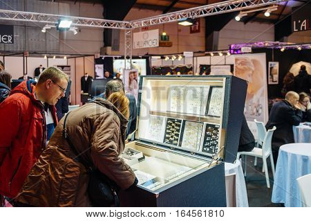 Strasbourg France - Jan 8 2017: Couple Choosing Wedding Rigns With Booths And People At Salon Du Mar