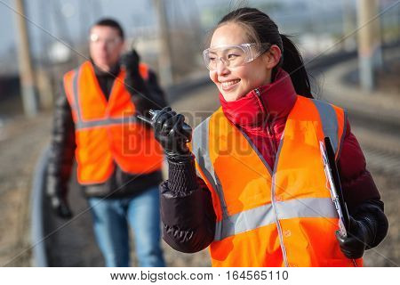 Man and a woman railroad workers maintaing railway