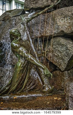 Norway Bergen . The foot of the monument - fountain to famous Norwegian composer and violinist Ole Bull . Bronze sculpture Scald playing the mythical harp.