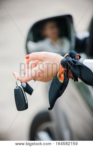 Car Keys. Seller woman hand giving keys