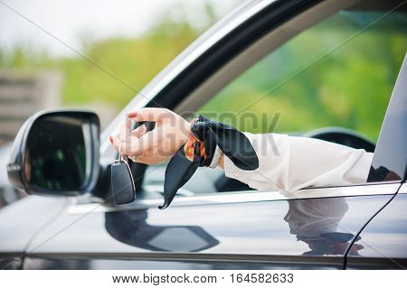 Car Keys. Seller woman hand giving keys