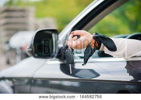 Car Keys. Seller woman hand giving keys