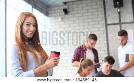 Beautiful young designers are working in office