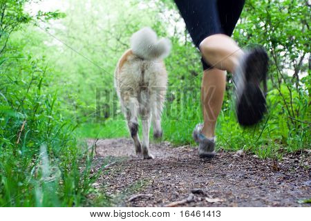 Woman Running Cross Country With Dog