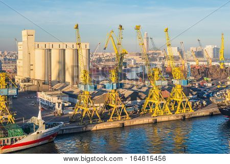 Casablanca Morocco - December 8 2016: View of the sea port in Casablanca Morocco in the early morning. The scene with harbor cranes elevators ships and export cargoes in the port.