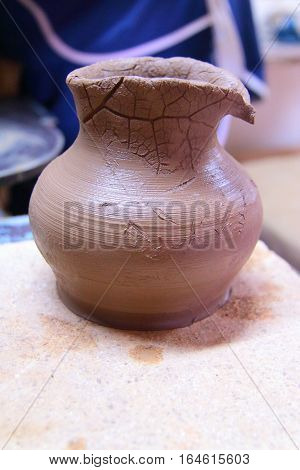 A clay pot, pottery craft, moulding the pot with your hands, sculpting hands