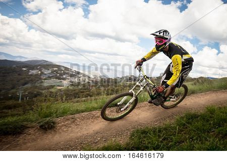 Mt Buller, Australia - January 4, 2017: Downhill mountain bike riders attempt the ABOM and International tracks on January 4, 2017 in Mt Buller, Australia