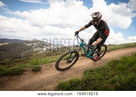Mt Buller, Australia - January 4, 2017: Downhill mountain bike riders attempt the ABOM and International tracks on January 4, 2017 in Mt Buller, Australia