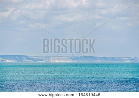 Albena, Bulgaria - June 13, 2016. View Of The Black Sea Shore, Green Hills With Windmills, Blue Clou