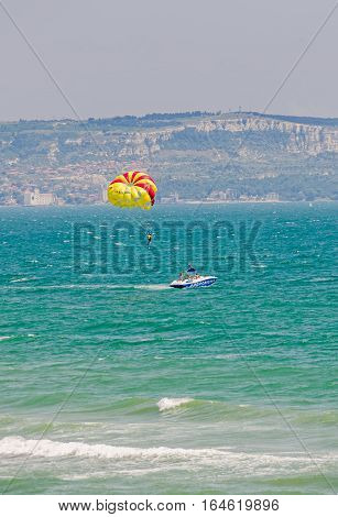Albena, Bulgaria - June 19, 2016. Colored Parasail Wing Pulled By A Boat In The Blue Water Sea.