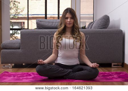 portrait of a woman doing yoga at home