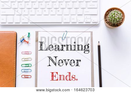 Text Learning never ends on white paper background / business concept