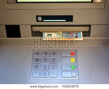 Keyboard Of An Atm With Money Coming Out