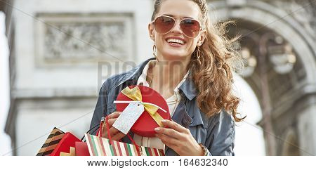Happy Woman With Christmas Present Near Arc De Triomphe In Paris