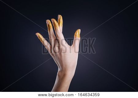 So tender. Pleasant slim hand of a woman making gestured against black background