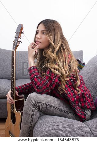 Portrait of a pensive girl with a guitar